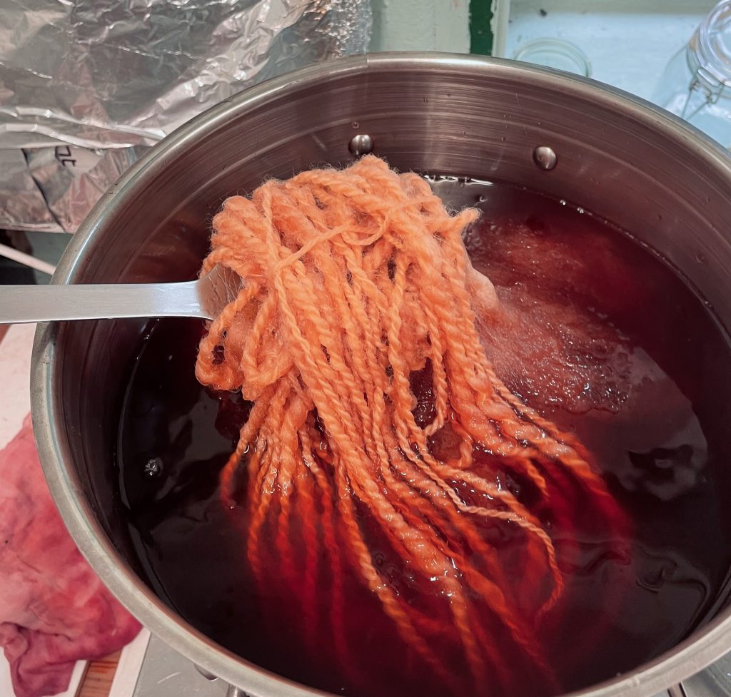 My process A metal dye pan full of orange coloured dye and yarn