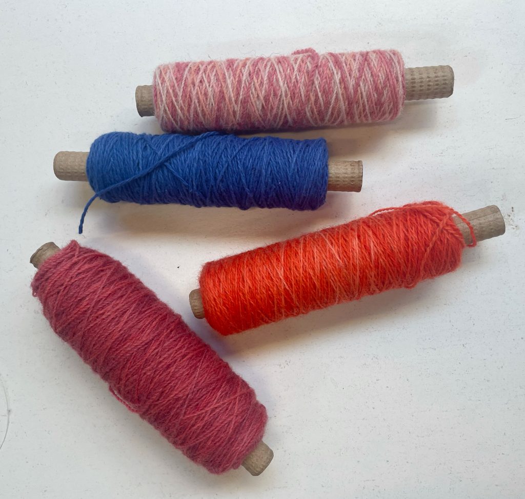 My process Hand-dyed yarn on cheeses ready to be used as weft yarns.