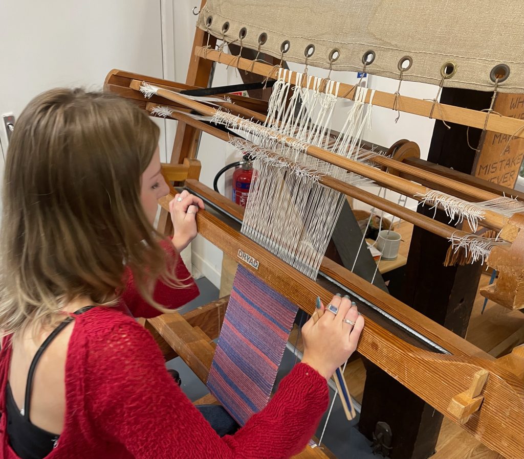 My process Weaving a scarf on a two shaft upright Dryad loom.
