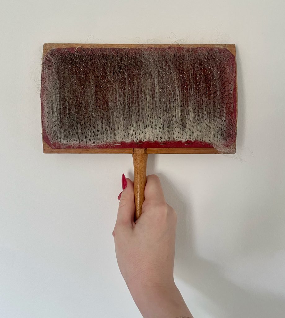 My process Carding fleece ready to spin.