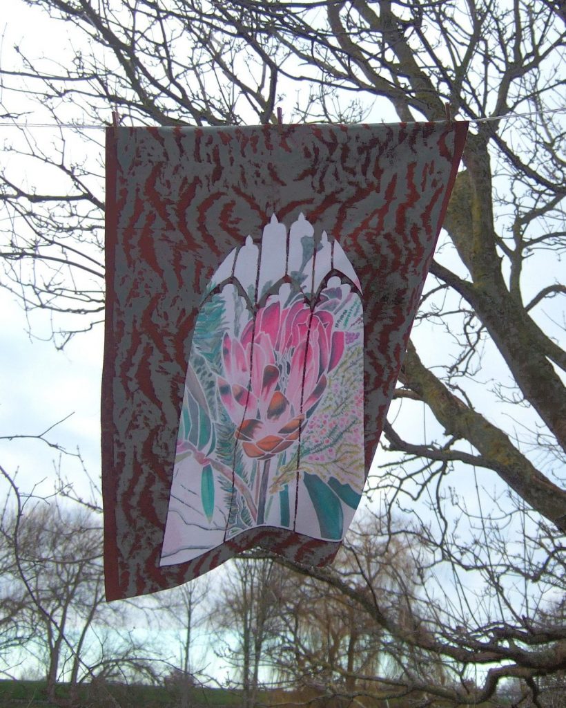 Fairytales Floral printed fabric pegged to a line in front of branches