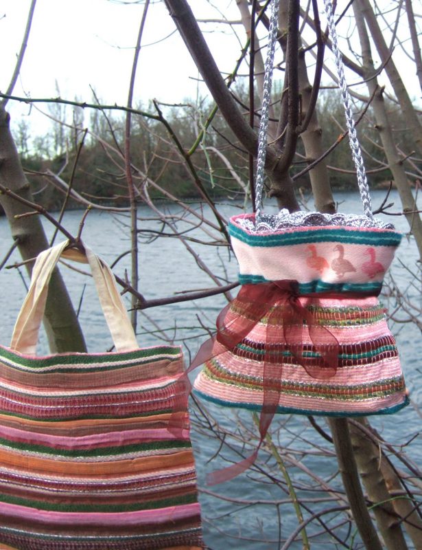 My work Visualisation of bags made from my design, hanging from a tree in front of water