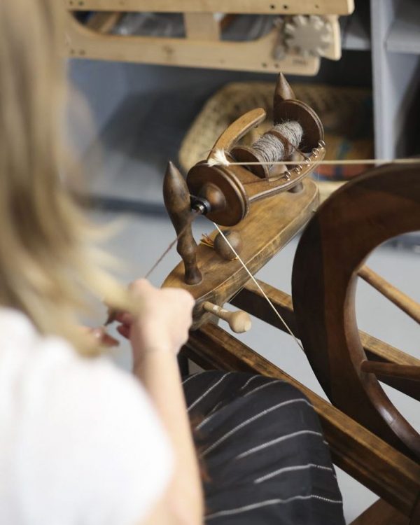 Millie Inman spinning yarn at Farfield Mill